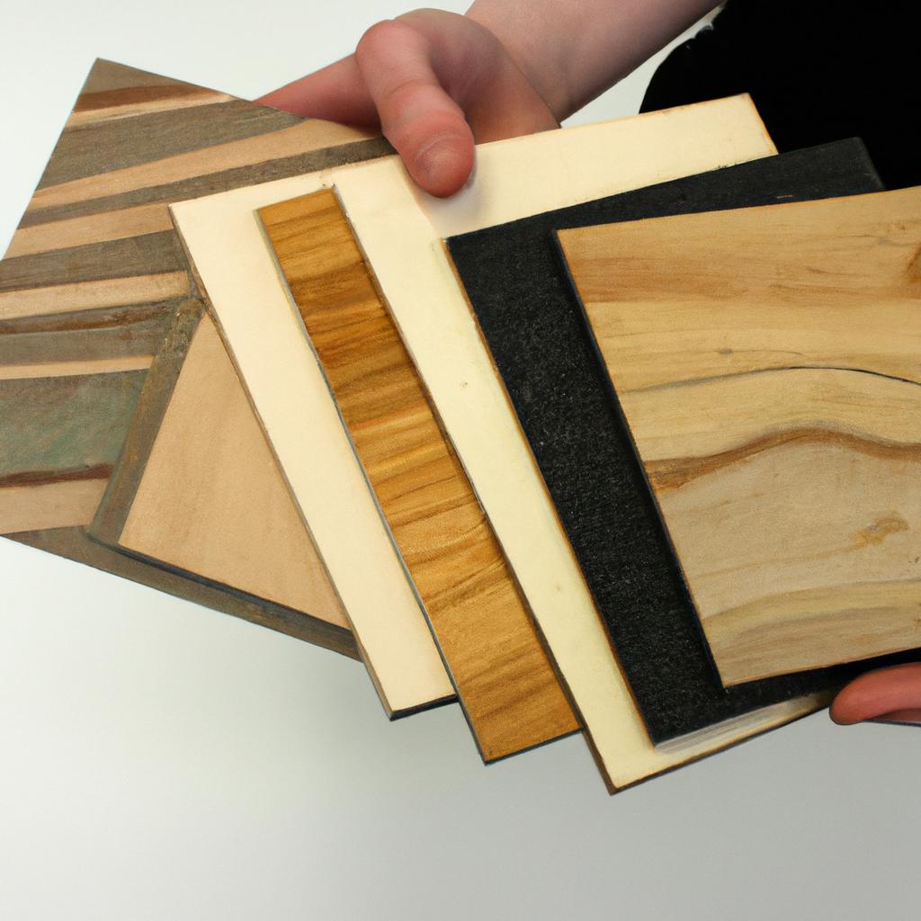 Person holding different plywood samples